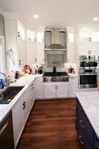 Remodeled kitchen with new cabinets, center island with marble countertops and updated a