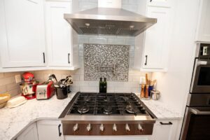 Remodeled kitchen with new cabinets, center island with marble countertops and updated a