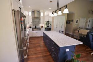 Remodeled kitchen with new cabinets, center island with marble countertops and updated appliances.